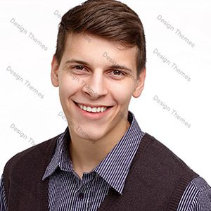 A man with brown hair and blue shirt smiling.