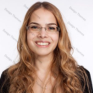 A woman with glasses smiling for the camera.