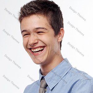 A young man smiling with his teeth hanging out of the side.