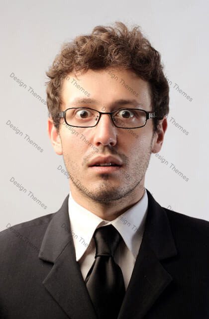 A man in a suit and tie with glasses.