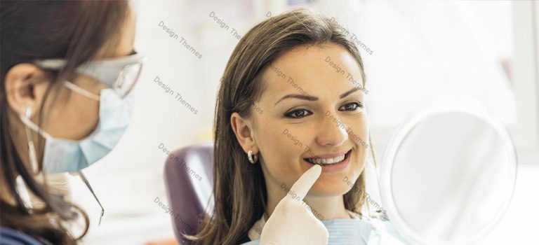 A woman sitting in the dentist chair smiling for the camera.