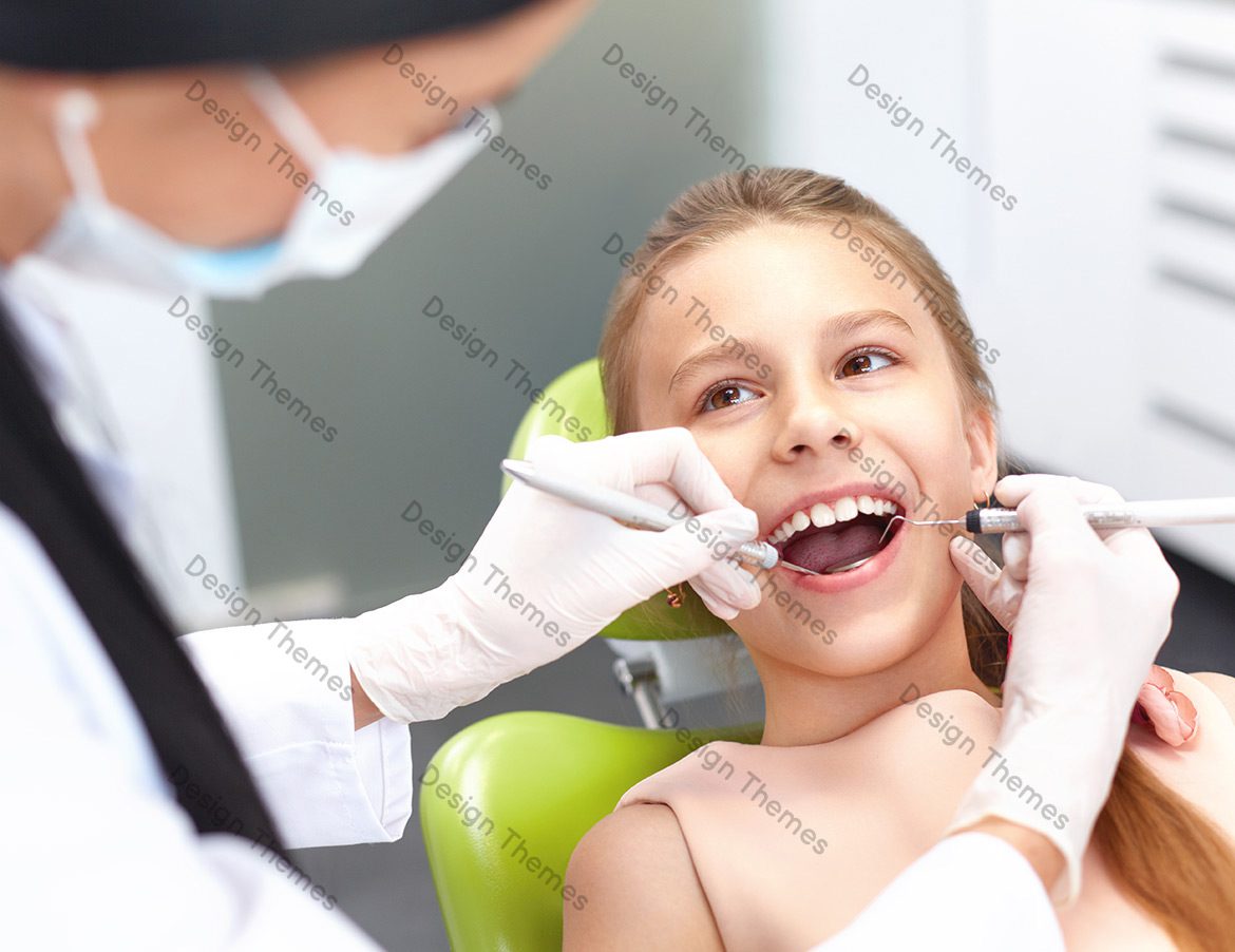 A young girl getting her teeth checked by an dentist.