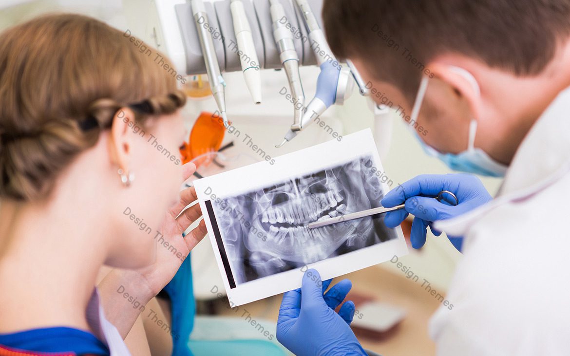 A dentist showing a patient an x-ray.